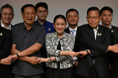 Pheu Thai party leader Paetongtarn Shinawatra (front center), known by her nickname “Ung Ing“ and the youngest daughter of former prime minister Thaksin Shinawatra, joins hands with coalition party leaders at a press conference as she is named the candidate to be Thailand's next prime minister at Shinawatra Tower in Bangkok on August 15, 2024. Thailand's Pheu Thai party chose Paetongtarn Shinawatra, the daughter of billionaire ex-PM Thaksin, as its candidate for prime minister, it said August 15, a day after a court dismissed the incumbent premier in an ethics case.