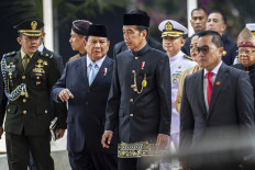 President Joko “Jokowi“ Widodo (center) talks with Defense Minister and president-elect Prabowo Subianto (second left) after attending the annual People's Consultative Assembly (MPR) plenary meeting at the Senayan legislative complex in Jakarta on Aug. 16, 2024.
