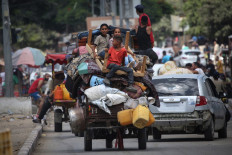 Palestinians flee with their belongings Deir el-Balah in the central Gaza Strip on Aug. 16, 2024, amid the ongoing conflict between Israel and the Hamas militant group.