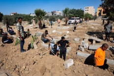 Palestinians dig graves at the al-Zawaida Cemetery, after the Israeli bombardment of the al-Bureij refugee Camp, in the central Gaza Strip on July 31, 2024, amid the ongoing conflict between Israel and the Palestinian Hamas militant group. Israel's campaign in Gaza has killed 39,400 people as of July 30, according to the health ministry in the Hamas-run territory, which does not provide details of civilian and militant deaths. The war began after Palestinian Hamas militants attacked Israel on October 7, which resulted in the death of 1,197 people, mostly civilians, according to an AFP tally based on official Israeli figures