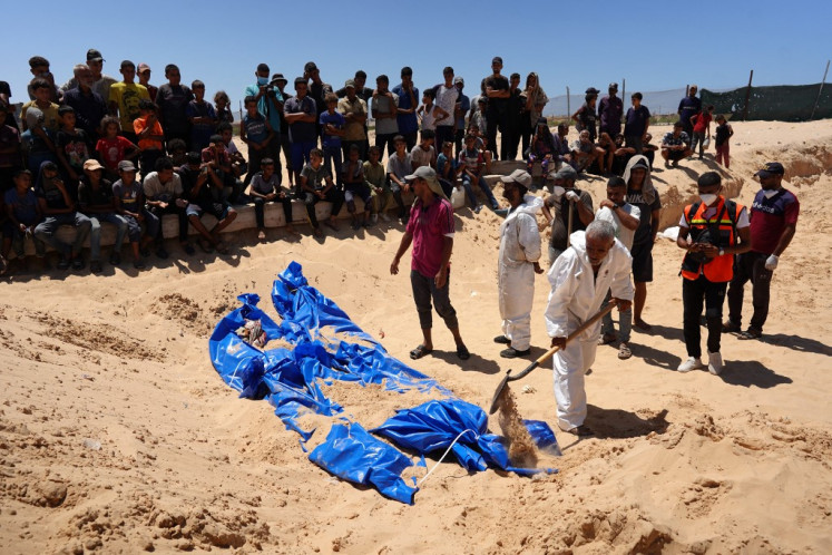 Men burry bodies that were taken and later released by Israel during a mass funeral at a cemetery in Khan Yunis in the southern Gaza Strip on Aug. 5, 2024, amid the ongoing conflict between Israel and the Palestinian Hamas militant group.
