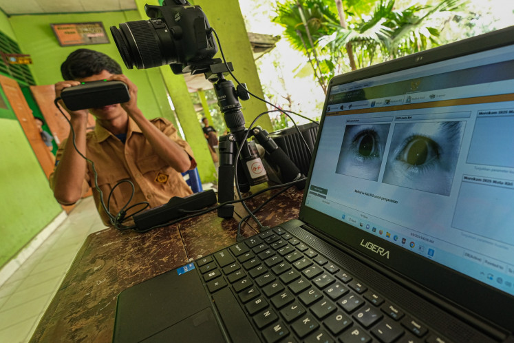A student scans his retina on Aug. 8, 2024 in Kendari, Southeast Sulawesi, to submit his biodata for an electronic identity card.