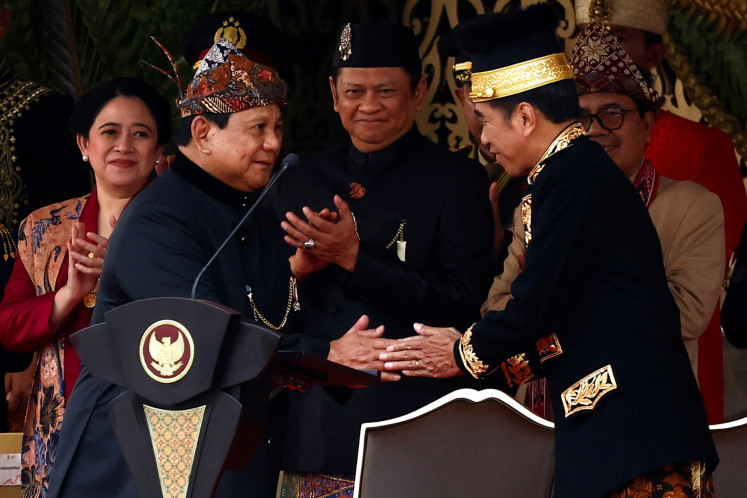 President Joko “Jokowi“ Widodo (right) shakes hands with Defense Minister and president-elect Prabowo Subianto during the national flag rising ceremony marking the country's 79th Independence Day in Nusantara Capital City (IKN), East Kalimantan on Aug. 17, 2024.