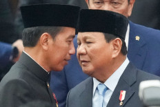 President Joko Widodo (left), wearing traditional Betawi attire, talks with Defence Minister and president-elect Prabowo Subianto after delivering his annual state of the nation address at the Senayan legislative complex in Jakarta on Aug. 16, 2024. 