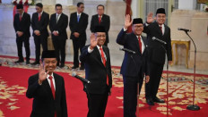 Goverment officials (from left) Bahlil Lahadalia, Supratman Andi Atgas, Roslan Roeslani and Angga Raka Prabowo wave on Aug. 19, 2014 at the State Palace, prior to their inauguration into the cabinet of outgoing President Joko “Jokowi” Widodo.