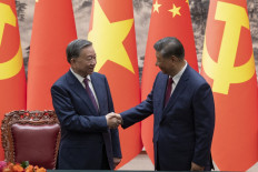 Chinese President Xi Jinping (right) and Vietnam President To Lam shake hands after a signing ceremony at the Great Hall of the People in Beijing on August 19, 2024.
