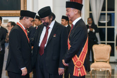 Communications and Information Minister Budi Arie Setiadi (left) talks with NasDem Party chairman Surya Paloh (center) and Industry Minister Agus Gumiwang Kartasasmita (right) during the state honors awarding ceremony at the State Palace in Jakarta on Aug. 14, 2024.
