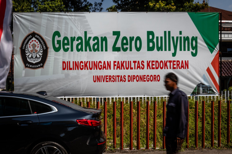 A security guard passes by a banner on Aug. 15, 2024, reading “Zero Bullying Movement in Diponegoro University's Medical School“ at the Dr. Kariadi General Hospital in Semarang, Central Java.
