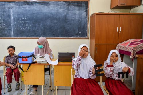Pupils of Pardomuan state elementary school in Bandung, West Java, take an eye test on Aug. 14, 2024 during the government-sponsored School Immunization Month.