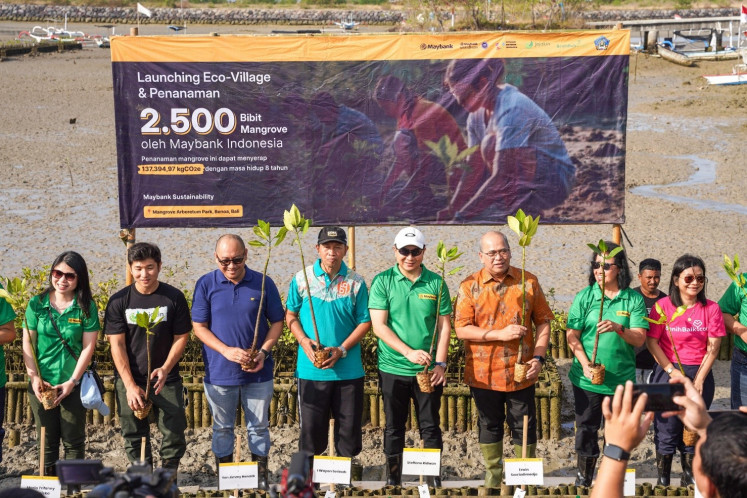 Head of sustainability at Maybank Indonesia Maria Trifanny Fransiska (from left), COO of Jejakin Andreas Djingga, deputy director of financial services institution supervision 2 OJK Bali Yan Jimmy Hendrik, assistant for economic and development affairs, secretary of the Bali provincial administration Dr. I Wayan Serinah, president director of Maybank Indonesia Steffano Ridwan, Bank Indonesia Bali representative head Erwin Soeriadimadja, trustee of the Maybank Foundation and chair of the Maybank Indonesia Foundation Budi Dyah Sitawati and chief of partnership at BenihBaik.com Greeny Dewayanti commence the mangrove planting ceremony at the Mangrove Arboretum Park, Bali, as part of the Maybank Marathon 2024 sustainability initiative.