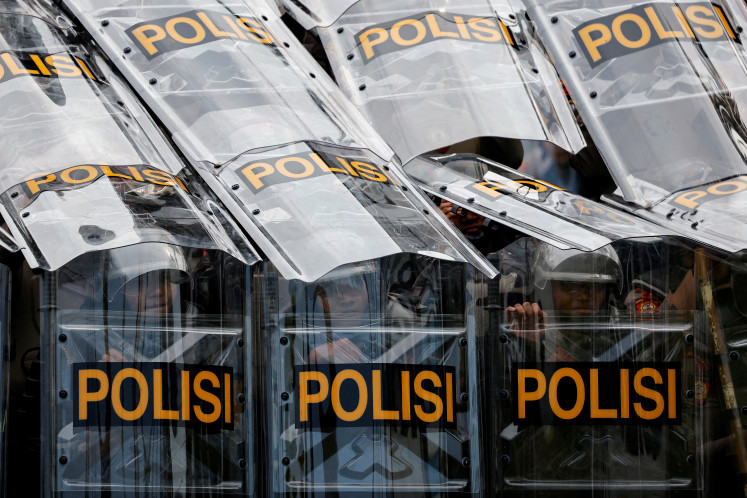 Riot police guard during a protest against planned controversial revisions to election law outside the Indonesian Parliament building in Jakarta, Indonesia, August 22, 2024. 