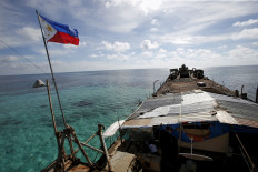 A Philippine flag flutters from BRP Sierra Madre, a dilapidated Philippine Navy ship that has been aground since 1999 and became a Philippine military detachment on the disputed Second Thomas Shoal, part of the Spratly Islands, in the South China Sea on March 29, 2014.