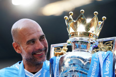 Manchester City manager Pep Guardiola celebrates with the trophy at the Etihad Stadium in Manchester, the United Kingdom on May 19, 2024 after winning the 2023-2024 season of Premier League.