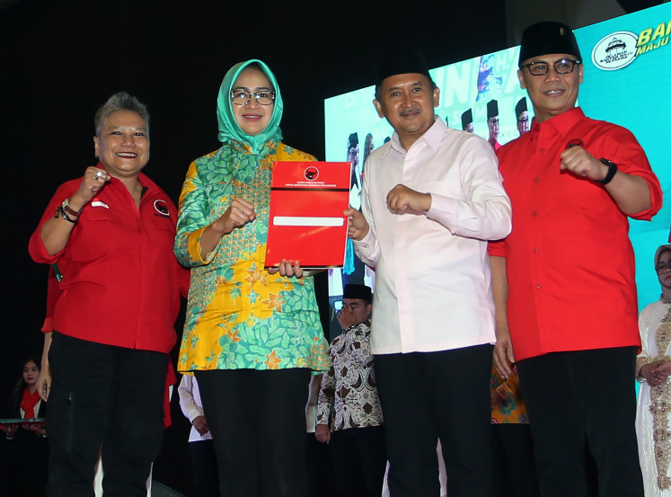 Indonesian Democratic Party of Struggle (PDI-P) executives Ribka Tjiptaning (left) and Ahmad Basarah (right) pose with the party’s Banten gubernatorial ticket, Airin Rachmi Diany (center left) and Ade Sumardi, during an event on Aug. 25, 2024 to announce the candidate pair in Tangerang, Banten.