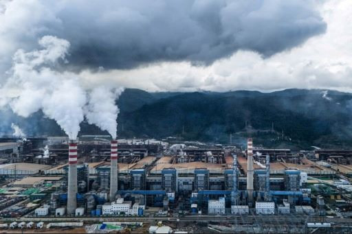 Smoke signs: Smoke billows out of chimneys in nickel smelting plants on July 7, 2024 at the Indonesia Weda Bay Industrial Park (IWIP) in Lelilef village, Central Halmahera regency, North Maluku.