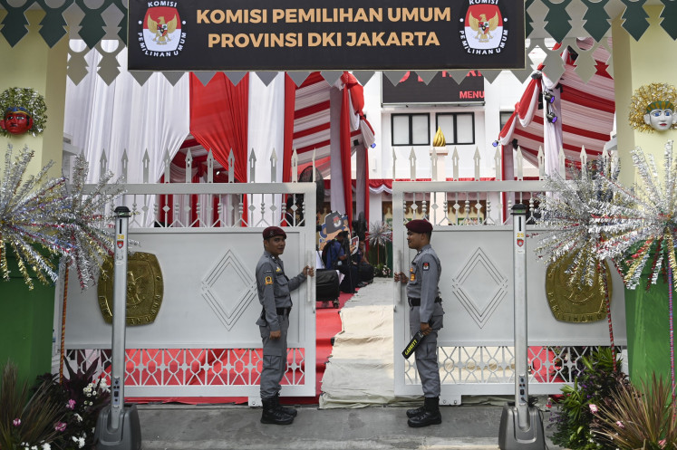 Security officers stand guard in front of the gate of the Jakarta General Elections Commission (KPU) in Jakarta on Aug. 27, 2024, the first day of the registration period for the candidates of the 2024 Jakarta gubernatorial election.