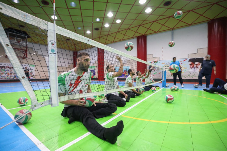 Iranian athlete Morteza Mehrzad takes part in a training session of the Iranian national sitting volleyball team in Tehran ahead of the Paris 2024 Paralympics on July 20, 2024. Iranian sitting volleyball star Morteza Mehrzad has overcome countless challenges due to his towering height, but now he is ready to help his team to another victory at the Paris Paralympics.