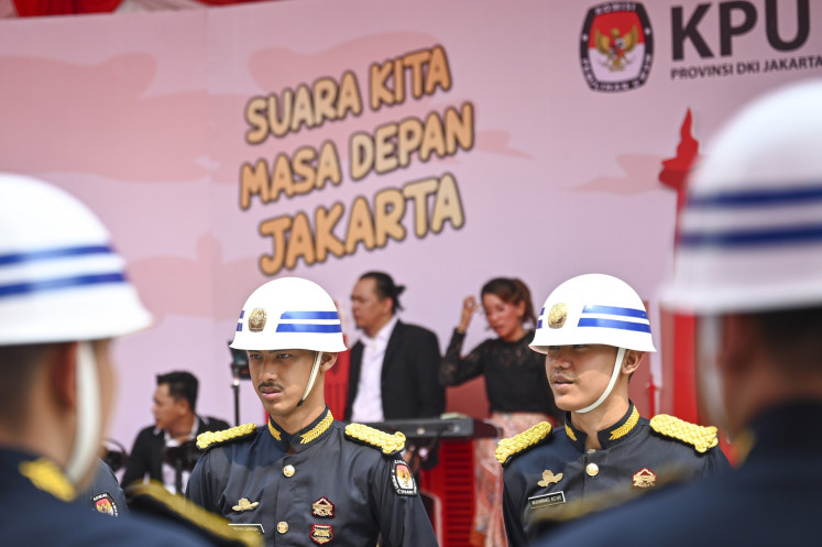 Security officers stand guard on the first day of the registration period for Jakarta gubernatorial candidates at the Jakarta General Elections Commission (KPU) in Jakarta on Aug. 27, 2024.