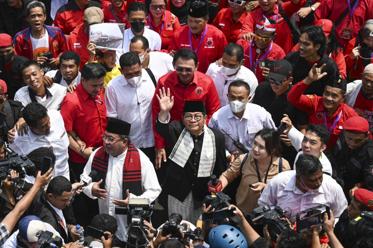 Jakarta gubernatorial hopeful Pramono Anung (center) and his running mate Rano Karno (front, left) greet supporters upon arriving at the Jakarta General Elections Commission (KPU) office in Jakarta on Aug. 28, 2024 to register their gubernatorial candidacy.