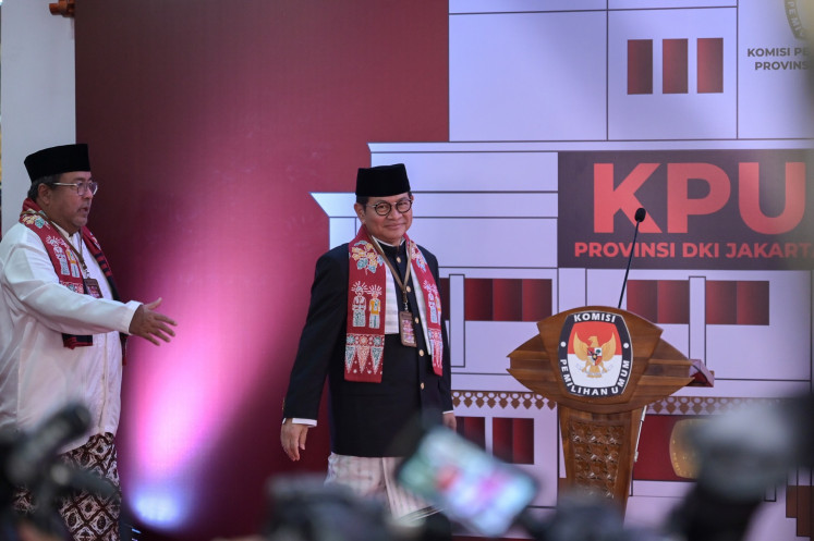 Jakarta gubernatorial candidate pair Cabinet Secretary Pramono Anung (right) and actor Rano Karno (left) walk to the podium after registering their candidacy at the Jakarta office of the General Elections Commission (KPU) on Aug. 28, 2024.