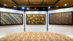 Three collaborative ASEAN batik motifs, Batik Udan Liris Sewelas Nagari (left), ⁠Batik Sekar Jagad Sewelas Nagari (center) and ⁠Batik Lumbon Sewelas Nagari, are displayed during their reveal in Dharmawangsa, South Jakarta, on Aug. 27, 2024. The batik motifs were a collaboration between the Office of the Coordinating Economic Minster and the Warisan Budaya Indonesia Foundation to commemorate the 57th anniversary of ASEAN. 