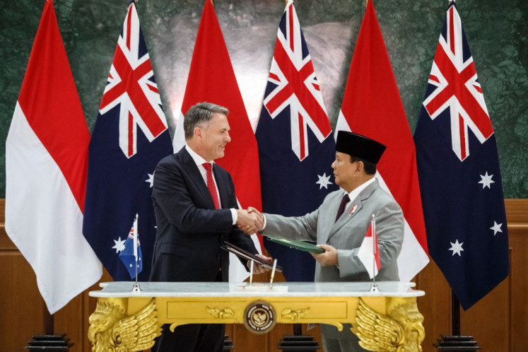 Defense Minister and president-elect Prabowo Subianto (right) and Australia's Deputy Prime Minister and Defense Minister Richard Marles shake hands after signing the Australia-Indonesia Defence Cooperation Agreement (DCA) at the Indonesian Army academy (akmil) in Magelang, Central Java, on Aug. 29, 2024. The pact, which includes provisions for joint drills and deployments to each country, was signed during Marles' visit to Indonesia this week.