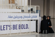 Women talk as draft of COP28 deal is negotiated at the same time during the United Nations Climate Change Conference (COP28) in Dubai, United Arab Emirates on Dec. 12, 2023.