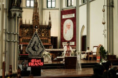 A banner welcoming Pope Francis is displayed as a priest performs a wedding ceremony at the Jakarta Cathedral in Jakarta on Aug. 30, 2024. The pontiff's 12-day trip to Indonesia, Papua New Guinea, East Timor and Singapore starting next week involves 43 hours of flight time and a distance of 32,000 kilometers.