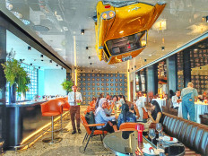 The New York-style ambience within The Coach Restaurant featuring an iconic yellow cab on the ceiling is seen on July 25, 2024, during a media gathering at the restaurant at the Grand Indonesia West Mall in Central Jakarta.