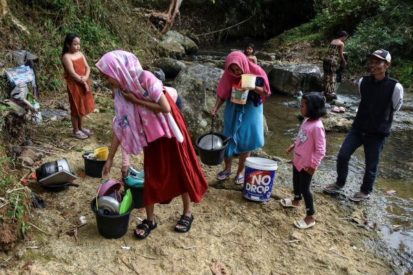 Residents of Gunung Tanjung village in Tasikmalaya regency, West Java, collect water from the Cipamutih River on Aug. 26, 2024 for daily consumption amid a prolonged drought.