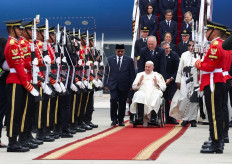 Religious Affairs Minister Yaqut Cholil Qoumas (left) welcomes Pope Francis (center) at Soekarno-Hatta International Airport in Tangerang, Banten on Sept. 3, 2024  during the pope's apostolic visit to Asia.