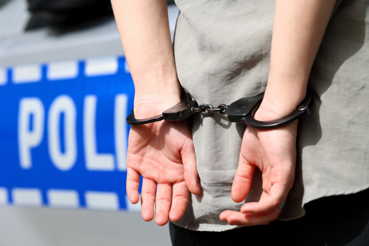 A stock illustration of a police arrest.