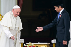 President Joko “Jokowi“ Widodo (right) and Pope Francis arrive for a meeting on Sept. 4, 2024, following a ceremonial welcome at the veranda of the Merdeka Palace in Jakarta. Pope Francis' grueling tour of the Asia-Pacific got into full swing on Sept. 4, with the 87-year-old appearing in good health and strong spirits as he met President Jokowi.