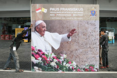Workers install a billboard on Sept. 3, 2024, for the upcoming Mass led by Pope Francis at the Gelora Bung Karno (GBK) Stadium in Jakarta, slated for Sept. 5. Pope Francis arrived in Indonesia on Sept. 3 to kick off a four-nation tour of the Asia-Pacific that will be the longest and farthest of the 87-year-old's papacy.