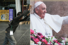 A worker installs a billboard on Sept. 3, 2024 for the upcoming Mass led by Pope Francis at the Gelora Bung Karno (GBK) Stadium in Jakarta, slated for Sept. 5. 