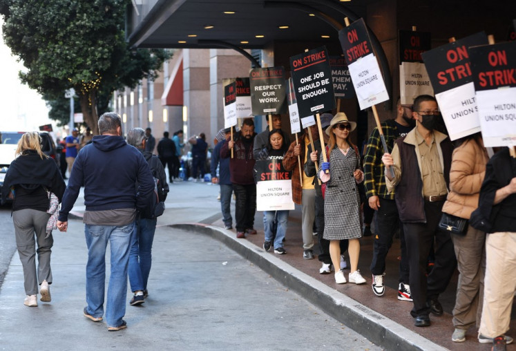 Union workers picket outside of the Hilton San Francisco Union Square hotel on Sept. 03, 2024, in San Francisco, California, United States. Over 10,000 hotel union workers are striking at 25 hotels in 9 US cities as they demand higher wages, fair workloads and reversing cuts implemented during the COVID pandemic.