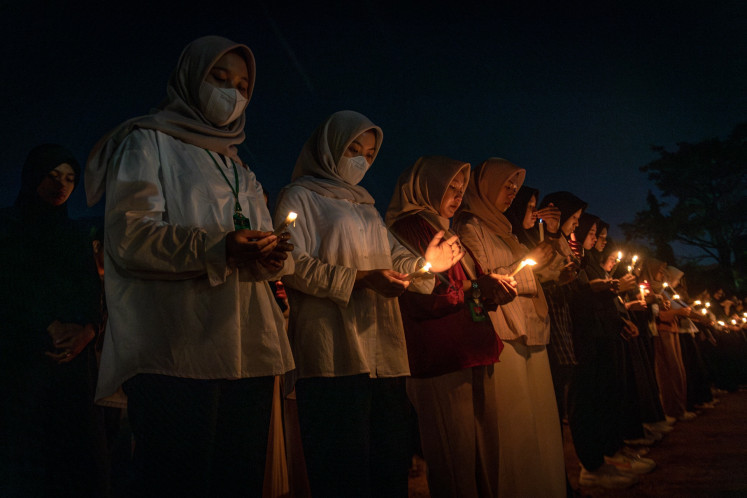 Members of Diponegoro University's Medicine School Student Executive Body (BEM) hold a vigil to commemorate a medical resident who committed suicide, allegedly as the result of bullying, at the campus in Semarang, Central Java on Sept. 2, 2024. 