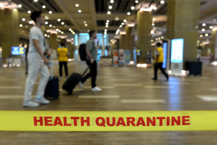 International passengers walk through the health examination area at I Gusti Ngurah Rai International Airport on Sept. 5, 2024, in Badung, Bali. The airport's health quarantine center is intensifying health surveillance amid the HMPV outbreak. 