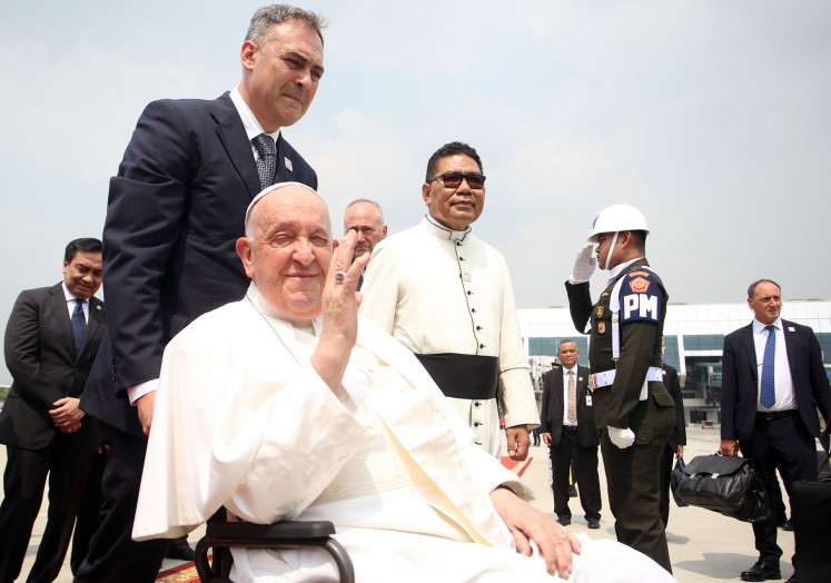 Pope Francis (center) waves ahead of his departure from the Soekarno-Hatta International Airport in Tangerang, Banten to Port Moresby, Papua New Guinea on Sept. 6, 2024.