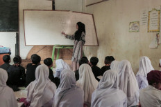 A teacher teachers students in a musholla (prayer room) of SDN Ciaripin state elementary school in Sukabumi regency, West Java on Aug. 22, 2024. Forty students are forced to relocate to the musholla in the past two months because their classrooms are heavily damaged.