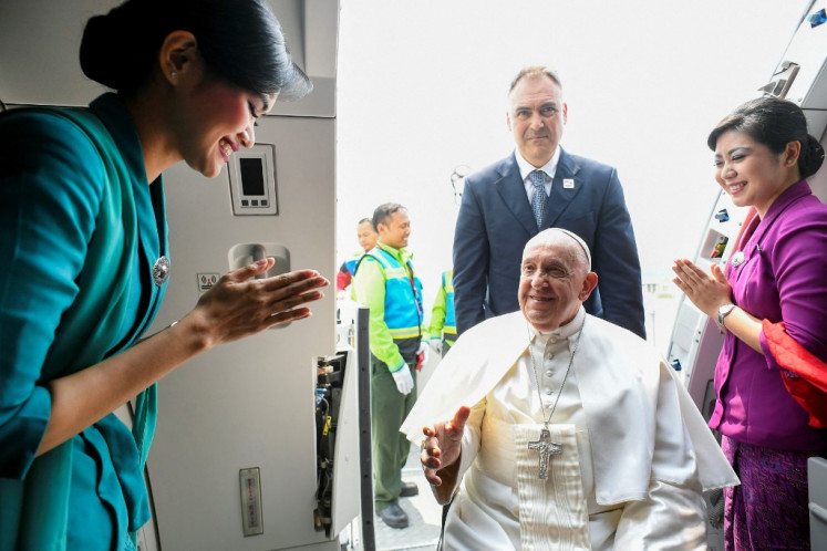 In this handout picture released by the Vatican Press Office on September 6, 2024 Pope Francis (center) boards a plane for his departure from Jakarta's Soekarno-Hatta International Airport to Papua New Guinea's capital Port Moresby. 