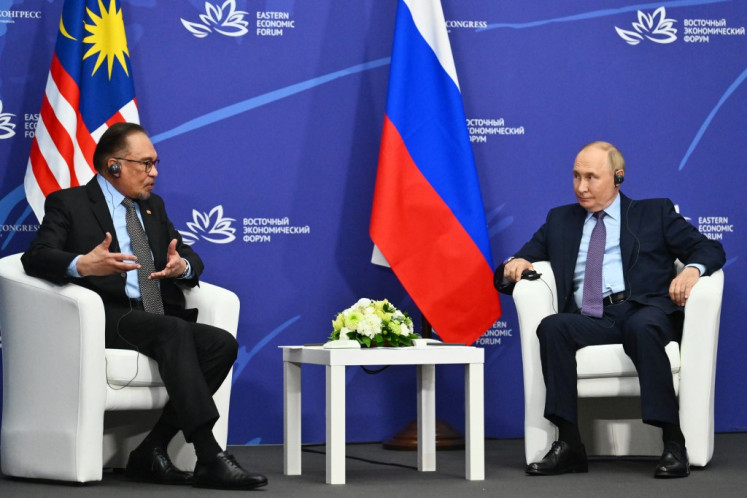 In this pool photograph distributed by the Russian state agency Sputnik, Russia's President Vladimir Putin meets with Malaysia's Prime Minister Anwar Ibrahim on the sidelines of the Eastern Economic Forum in Vladivostok on Sept. 4, 2024. 