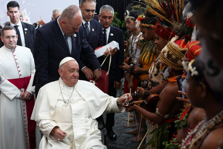 Pope Francis (second left, on wheelchair) greets indigenous people on the day of a meeting with authorities, civil society and the diplomatic corps at APEC Haus in Port Moresby, Papua New Guinea on Sept. 7, 2024.