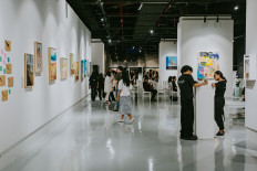 Visitors to the “Chapter 2: Dreams” art exhibition mill around at SPAC8, Ashta, in South Jakarta during the exhibition’s opening day on Sept. 6, 2024. The three-day exhibition was organized by Asmaraloka Chapters, which consists of students from the Jakarta International School, which aimed to raise funds for the education of underprivileged children.