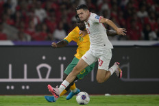 Indonesia's Justin Hubner (right) runs with the ball past Australia's Nestory Irankunda during the 2026 FIFA World Cup Asian qualification football match between Indonesia and Australia at Gelora Bung Karno Stadium in Jakarta on September 10, 2024. 