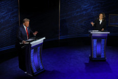 Republican presidential nominee, former U.S. President Donald Trump and Democratic presidential nominee, U.S. Vice President Kamala Harris both speak as they attend a presidential debate hosted by ABC in Philadelphia, Pennsylvania, U.S., September 10, 2024. 