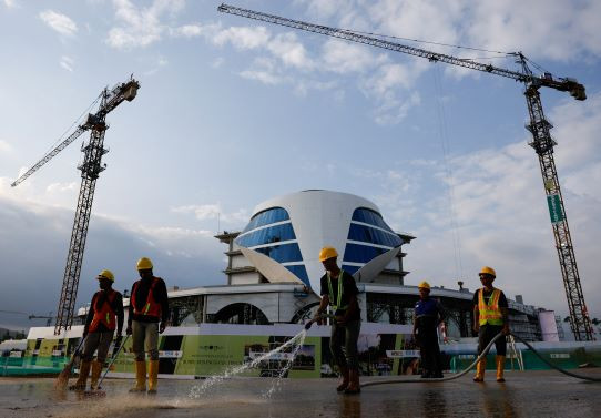 Gearing up: Workers clean the road near a construction site on Aug. 16, 2024, a day before the country's 79th Independence Day, in the new capital city of Nusantara, in East Kalimantan. 