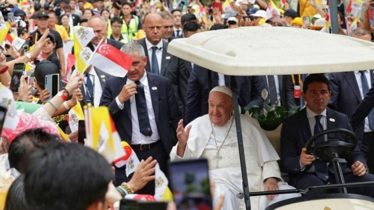 Pope Francis greets people at Jurassic Mile in Changi, Singapore on September 11, 2024. 