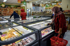 A woman takes a look at instant foods on offer in a supermarket in Cikutra, Bandung, West Java, on Sept. 3, 2024.