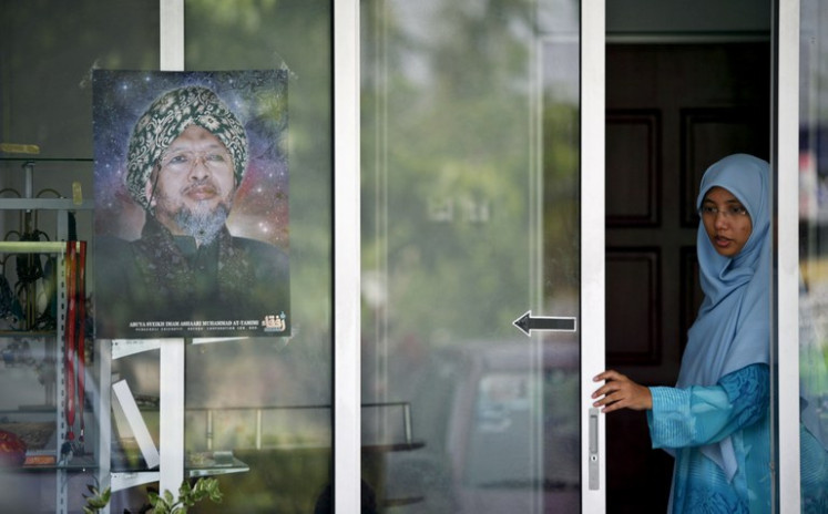 A poster of Malaysian Muslim preacher Ashaari Muhammad is on display outside his office in the Rufaqa commune in Rawang, outside Kuala Lumpur, December 6, 2006.